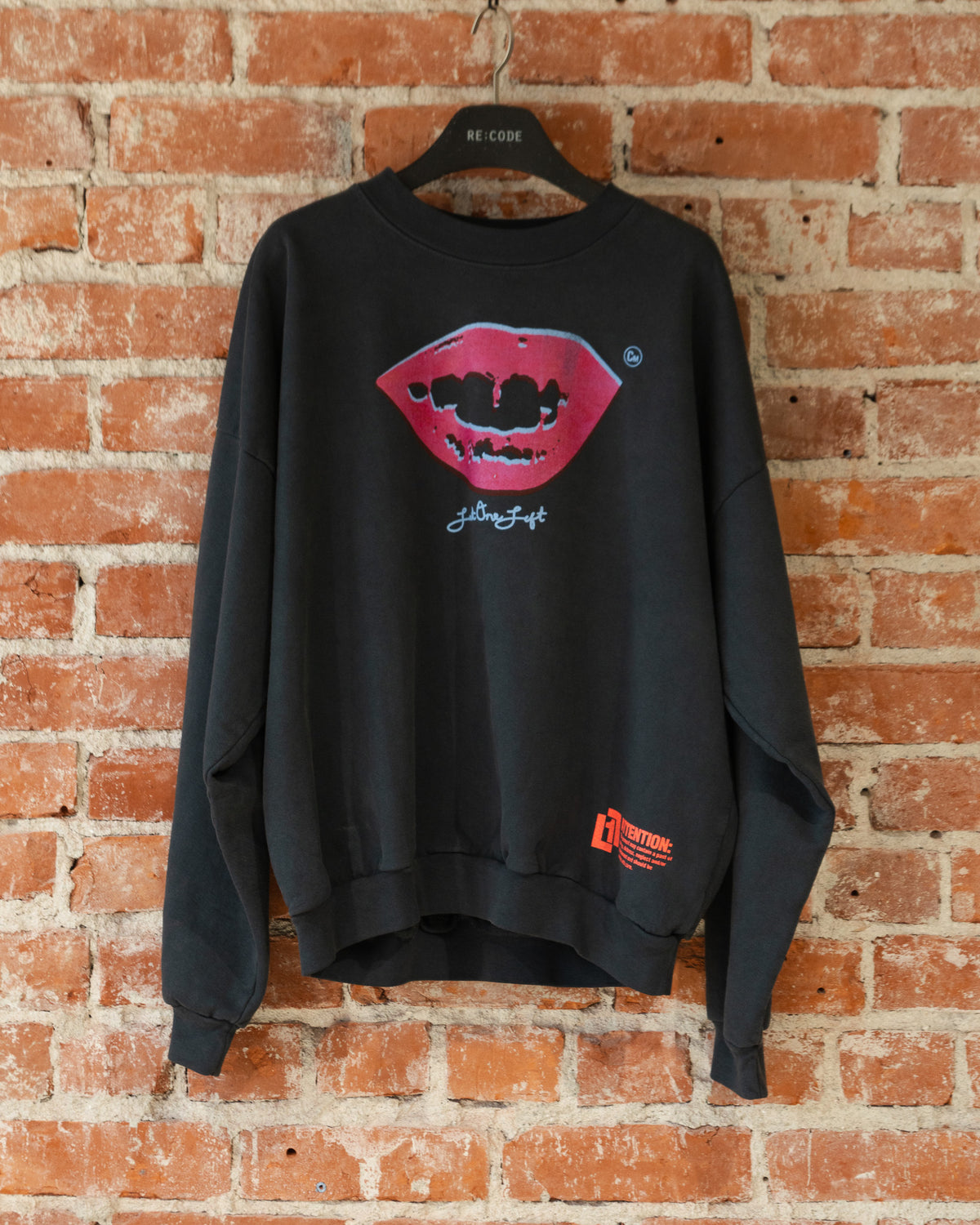 Smile Crewneck in Charcoal, closeup front view.