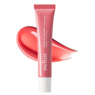 A pink squeeze tube of melixir Nourish Up Treatment + Vega Collagen lip care cream, shown upright with a glossy coral-pink product smear behind it on a white background.