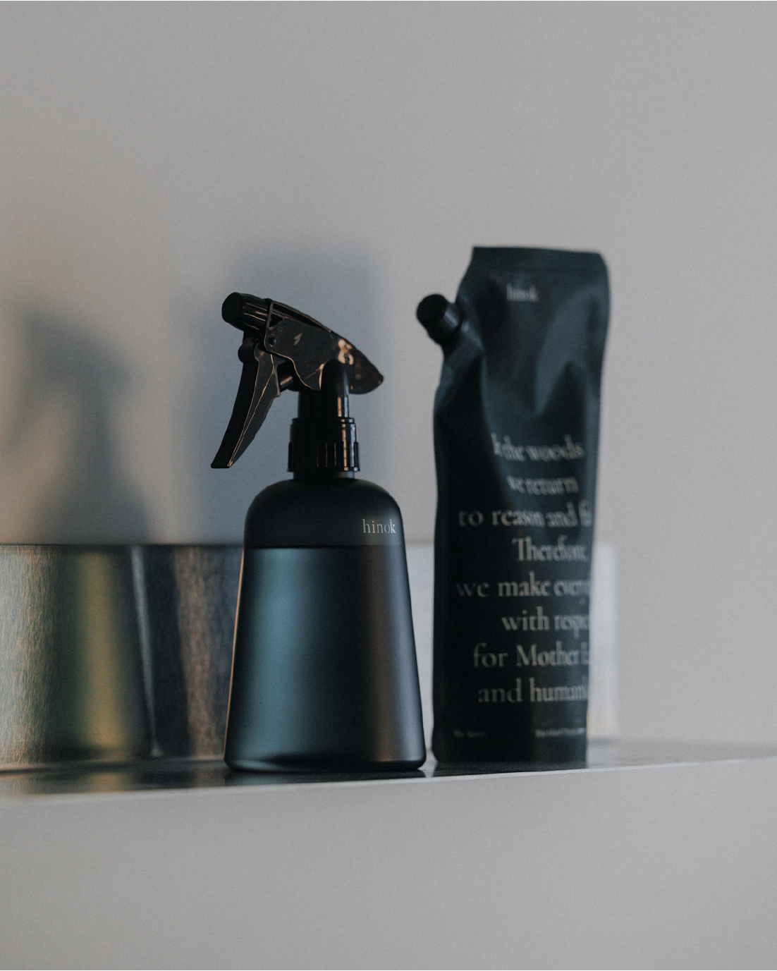 hinok The Spray bottle and refill in soft lighting.