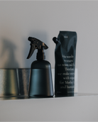 hinok The Spray bottle and refill in soft lighting.