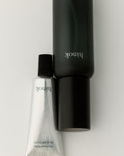 hinok The Spray in travel size shown next to hinok The Hand Balm.
