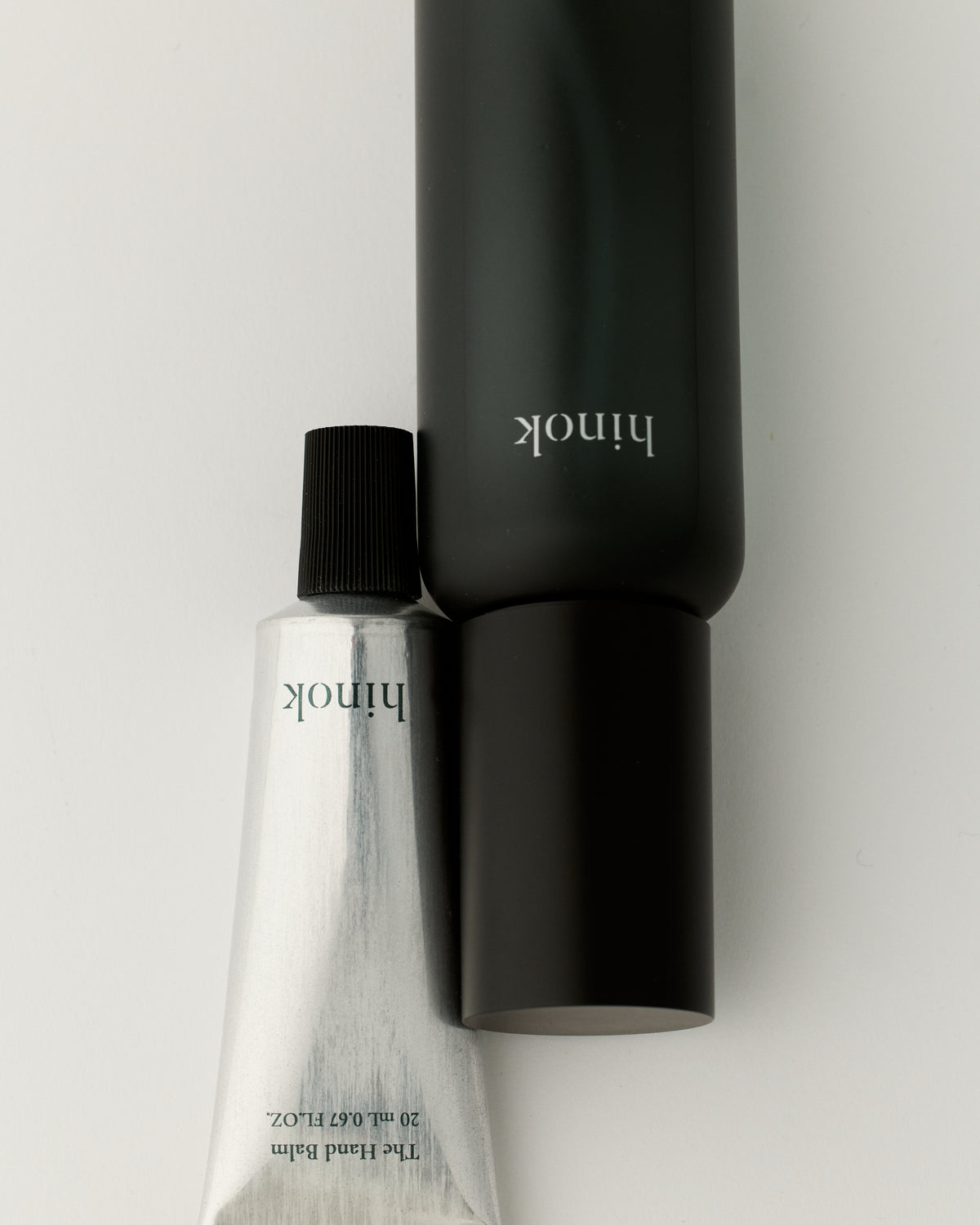 hinok The Spray in travel size shown next to hinok The Hand Balm.